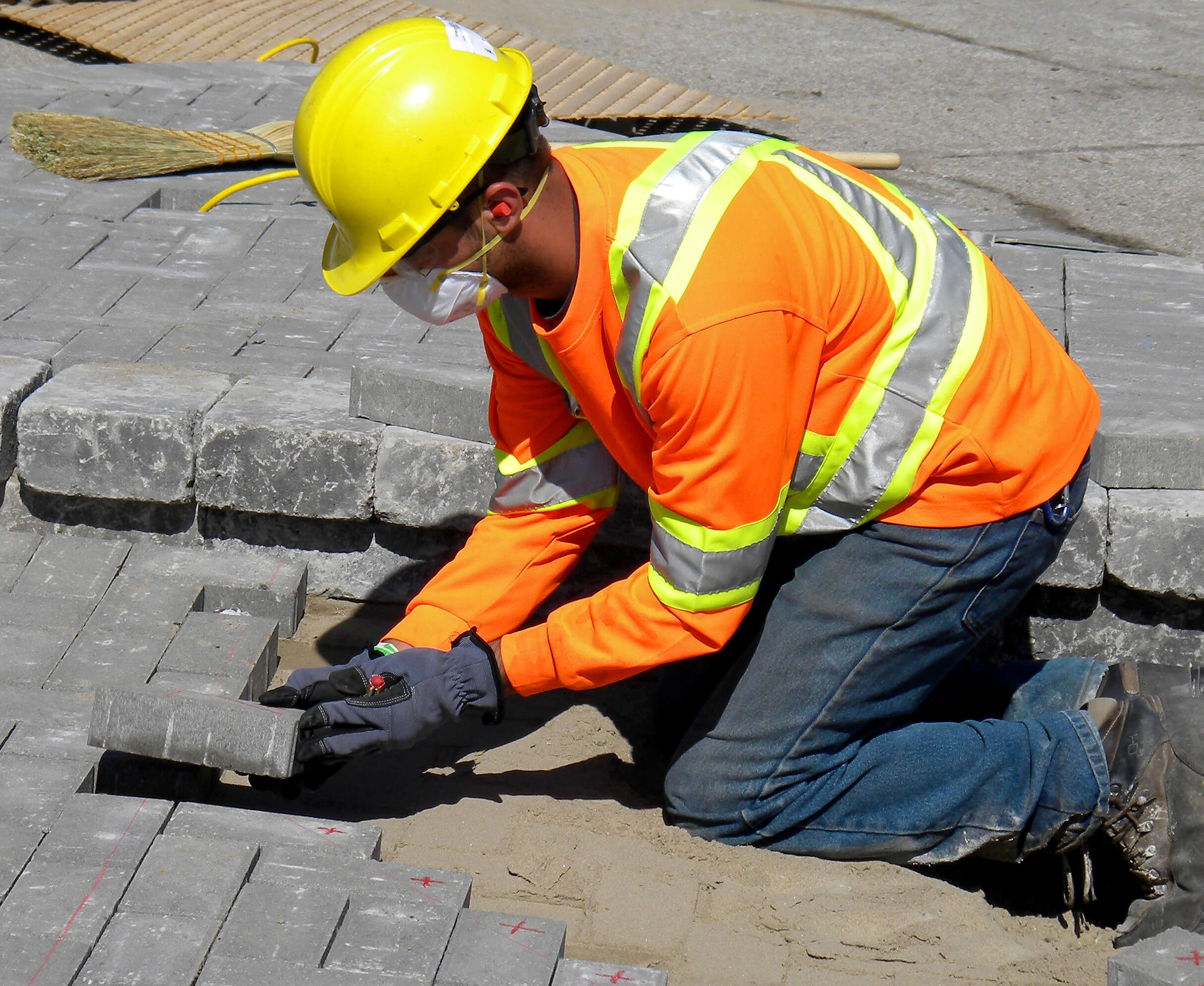Worker installing pavers